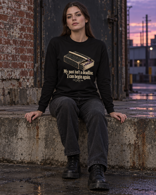 Unisex black long-sleeve crew tee with front quote graphic and crew neckline
