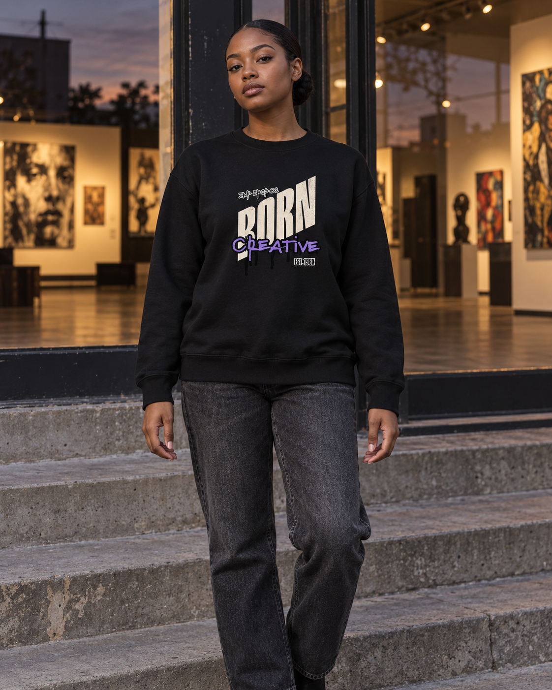 Black crewneck sweatshirt with Born Creative graphic, model front view