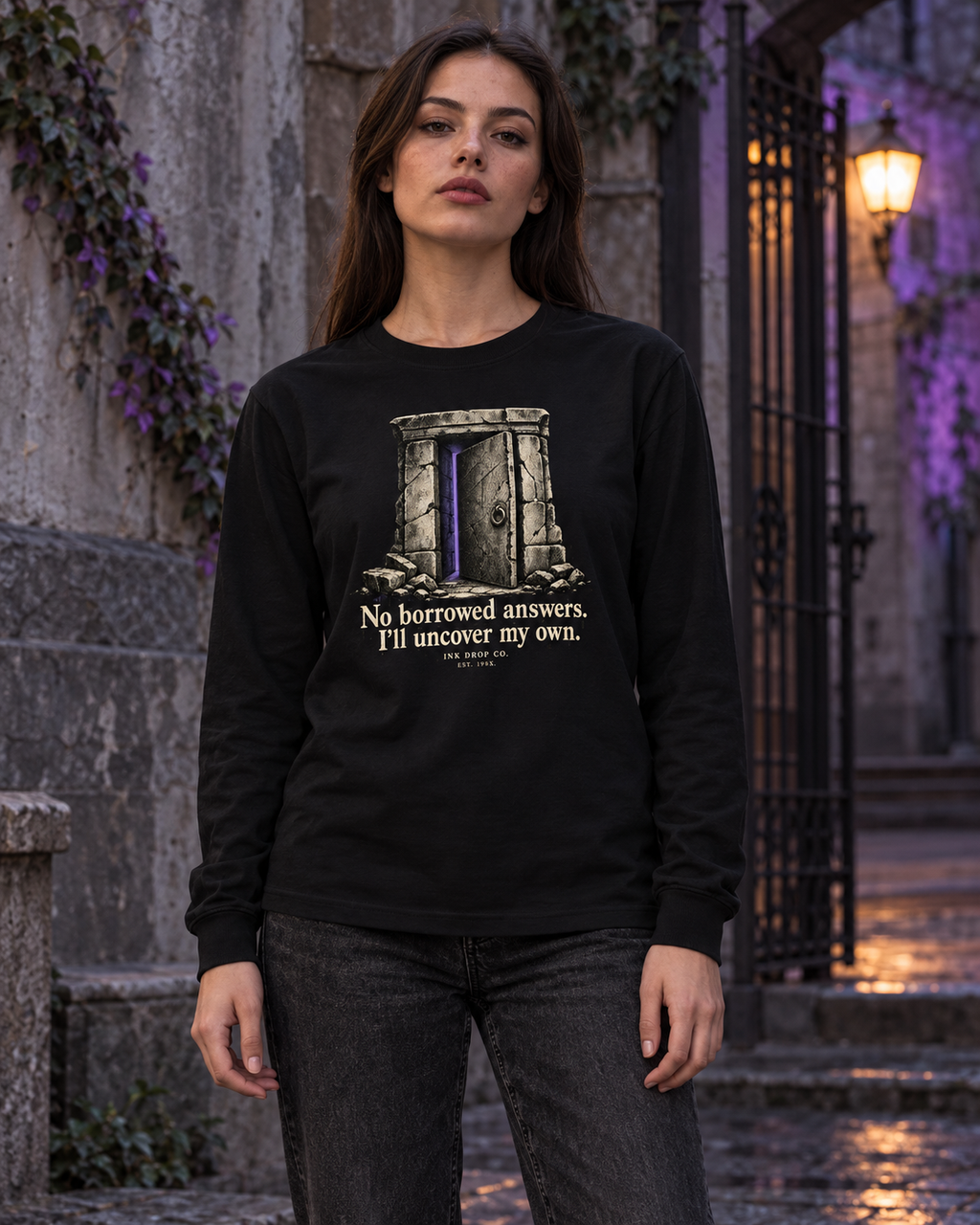 Black unisex long-sleeve graphic tee on model, centered door and quote print