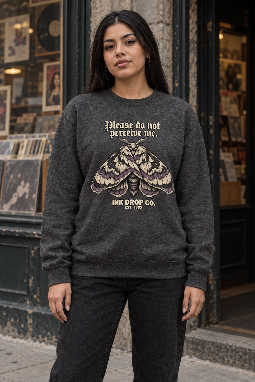 Heather gray unisex crewneck sweatshirt on model with moth graphic front print