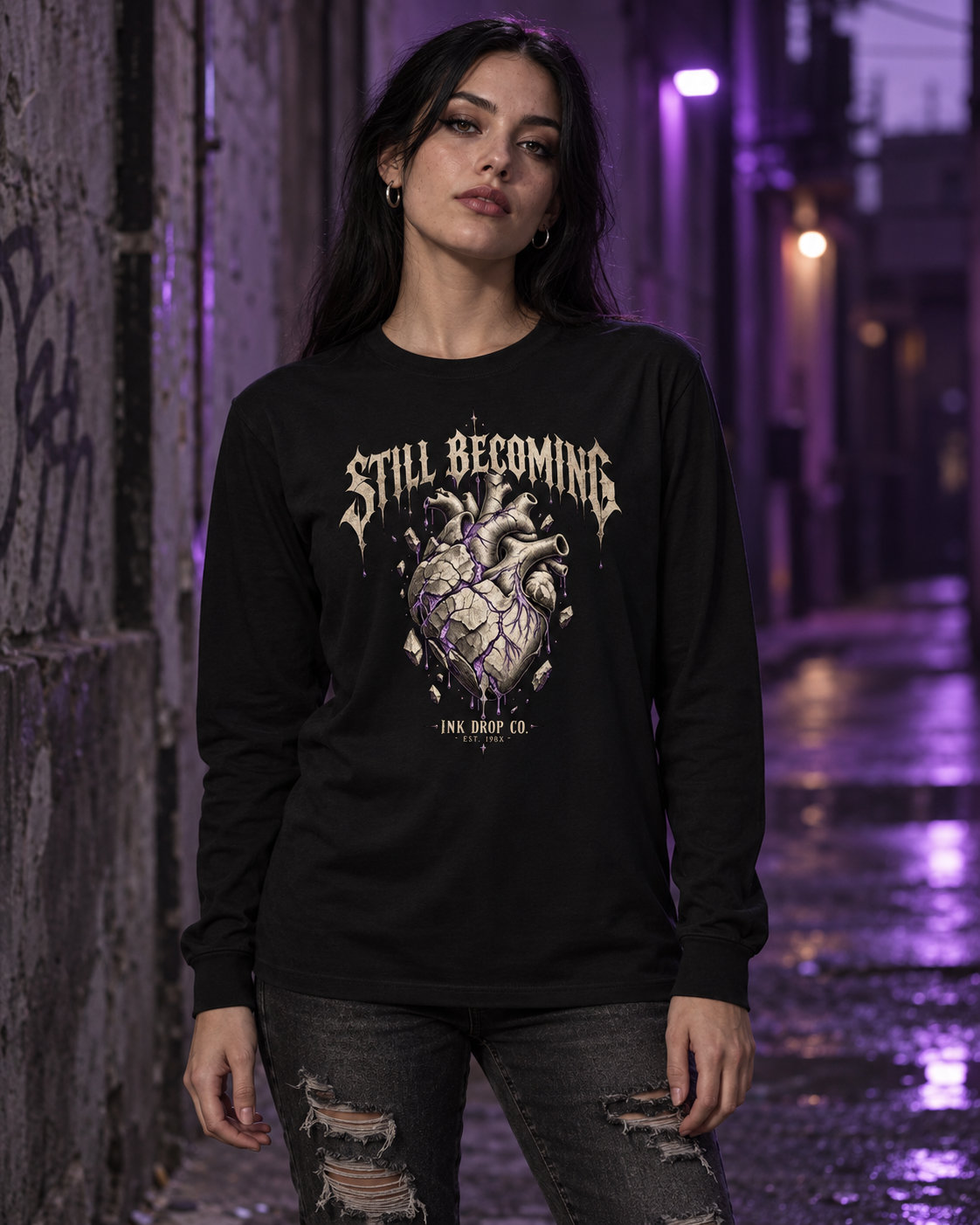 Black unisex long-sleeve graphic tee on model, front heart and text print visible