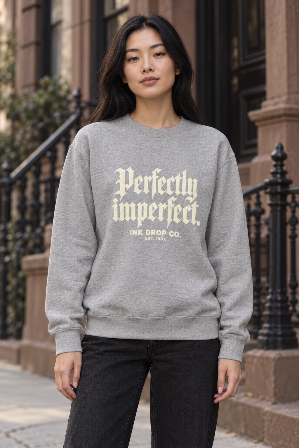 Unisex crewneck sweatshirt, heather gray, with gold typography graphic on the front