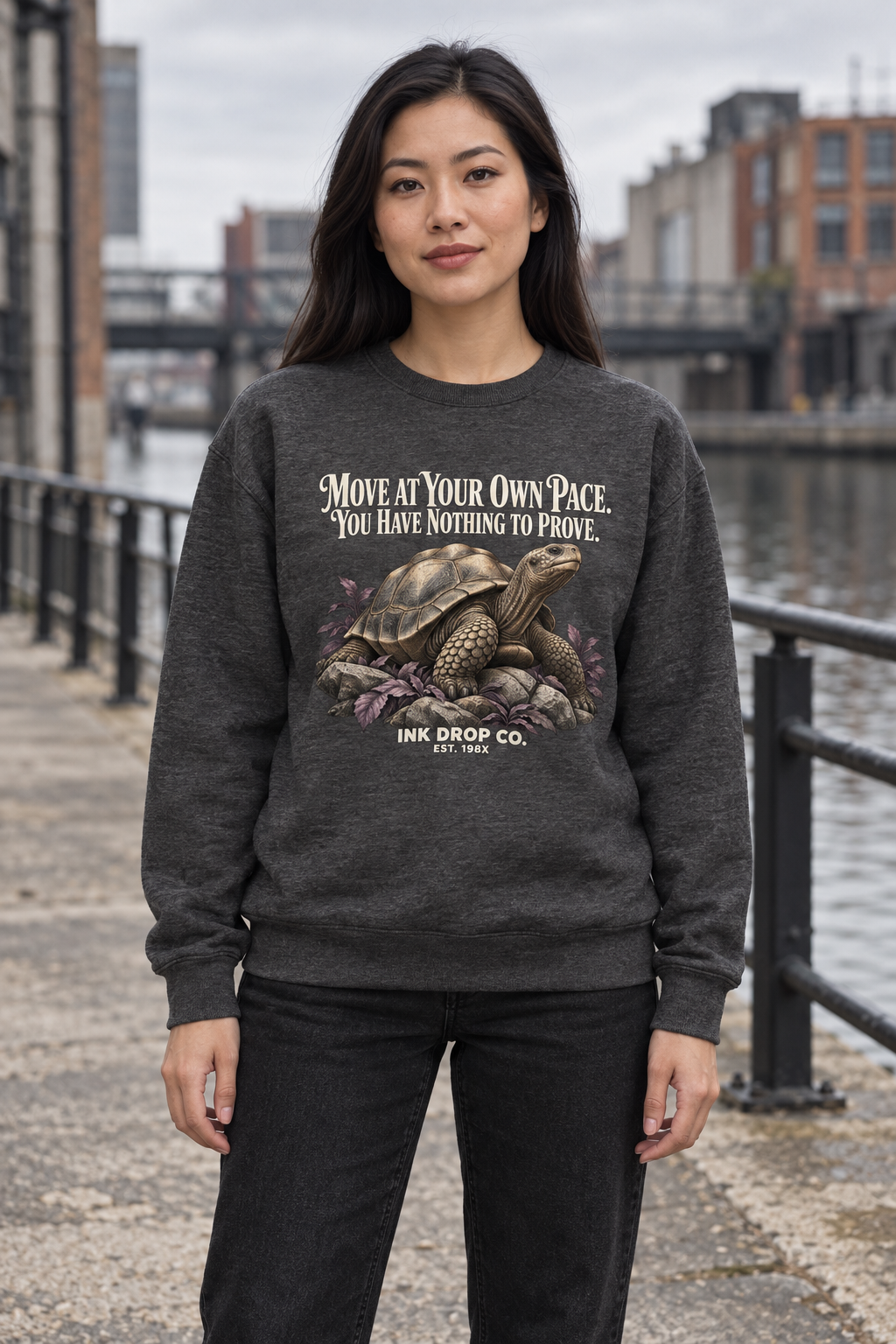 Unisex crewneck sweatshirt in dark charcoal gray with front graphic text and dragon emblem