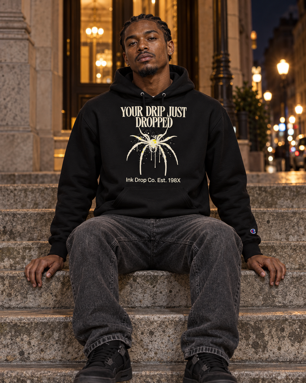 Black unisex graphic hoodie with front text and drip illustration, hooded pullover worn