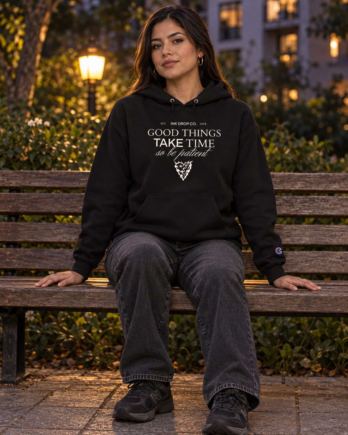 Black unisex pullover hoodie with "Good Things Take Time" chest graphic and hood