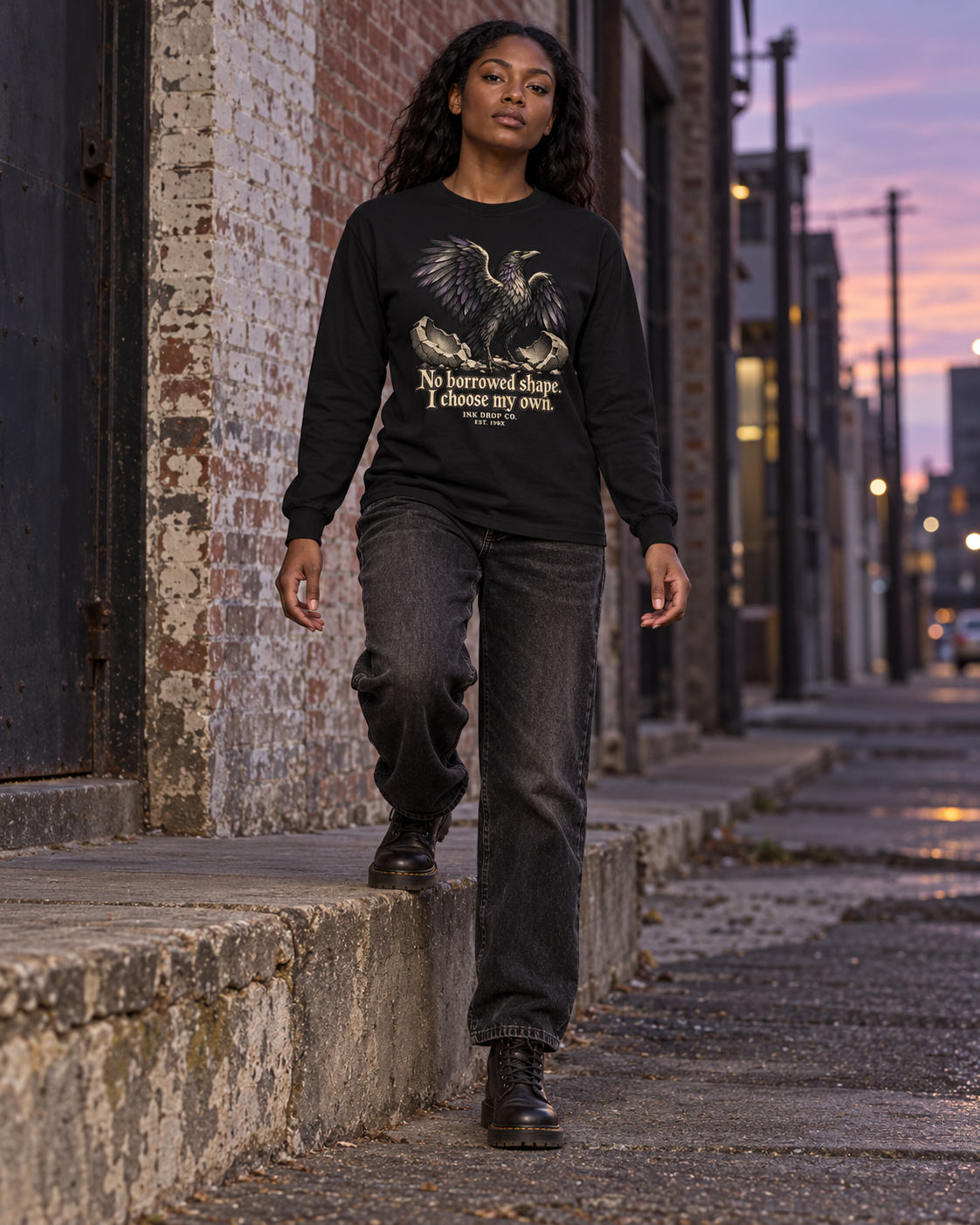 Black unisex long-sleeve graphic tee on model, front eagle and quote print.