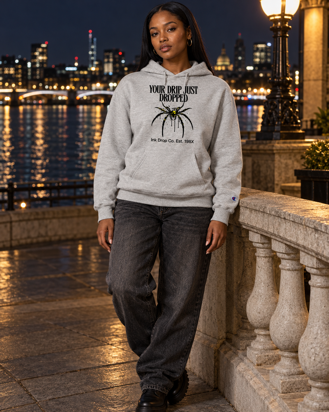 Light steel unisex graphic hoodie on model, front “YOUR DRIP JUST DROPPED” print.