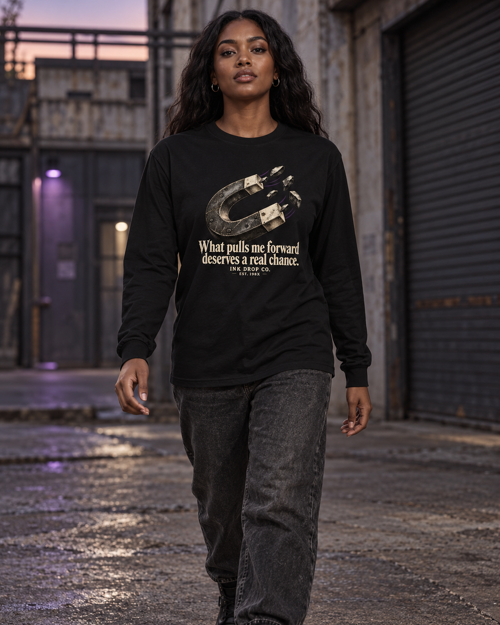 Unisex black long sleeve graphic tee on model, crew neck and front horseshoe print