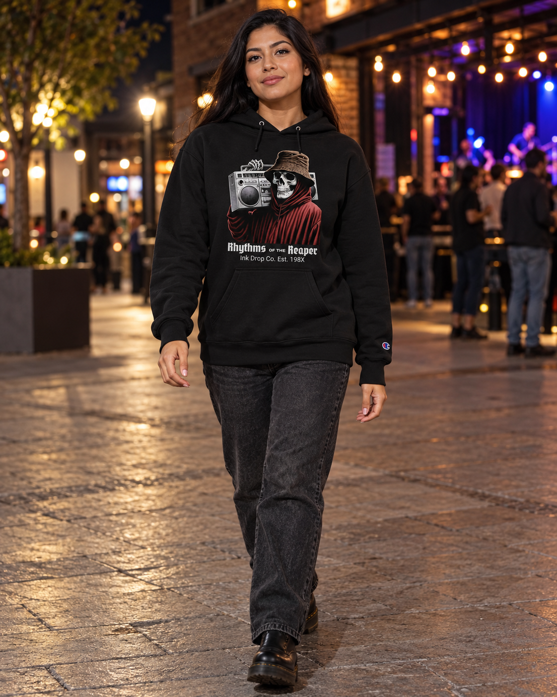 Unisex black pullover hoodie on model with front skull camcorder graphic and hood