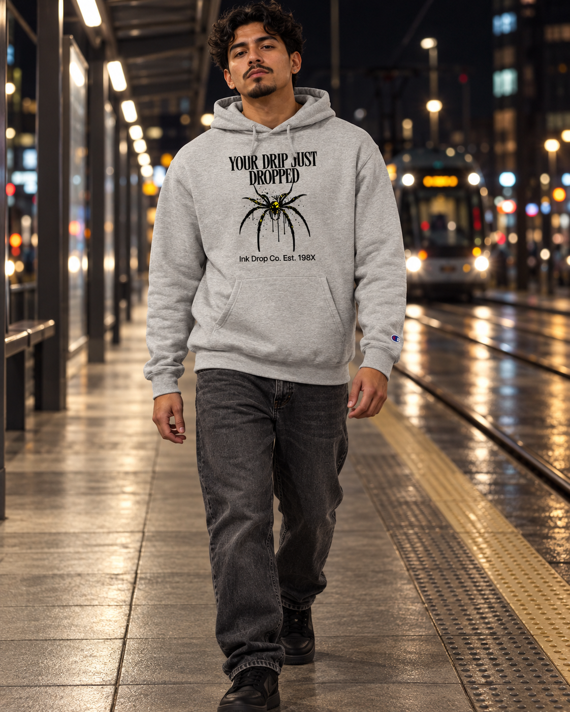 Light steel unisex graphic hoodie on model, front pocket and “YOUR DRIP JUST DROPPED” print.