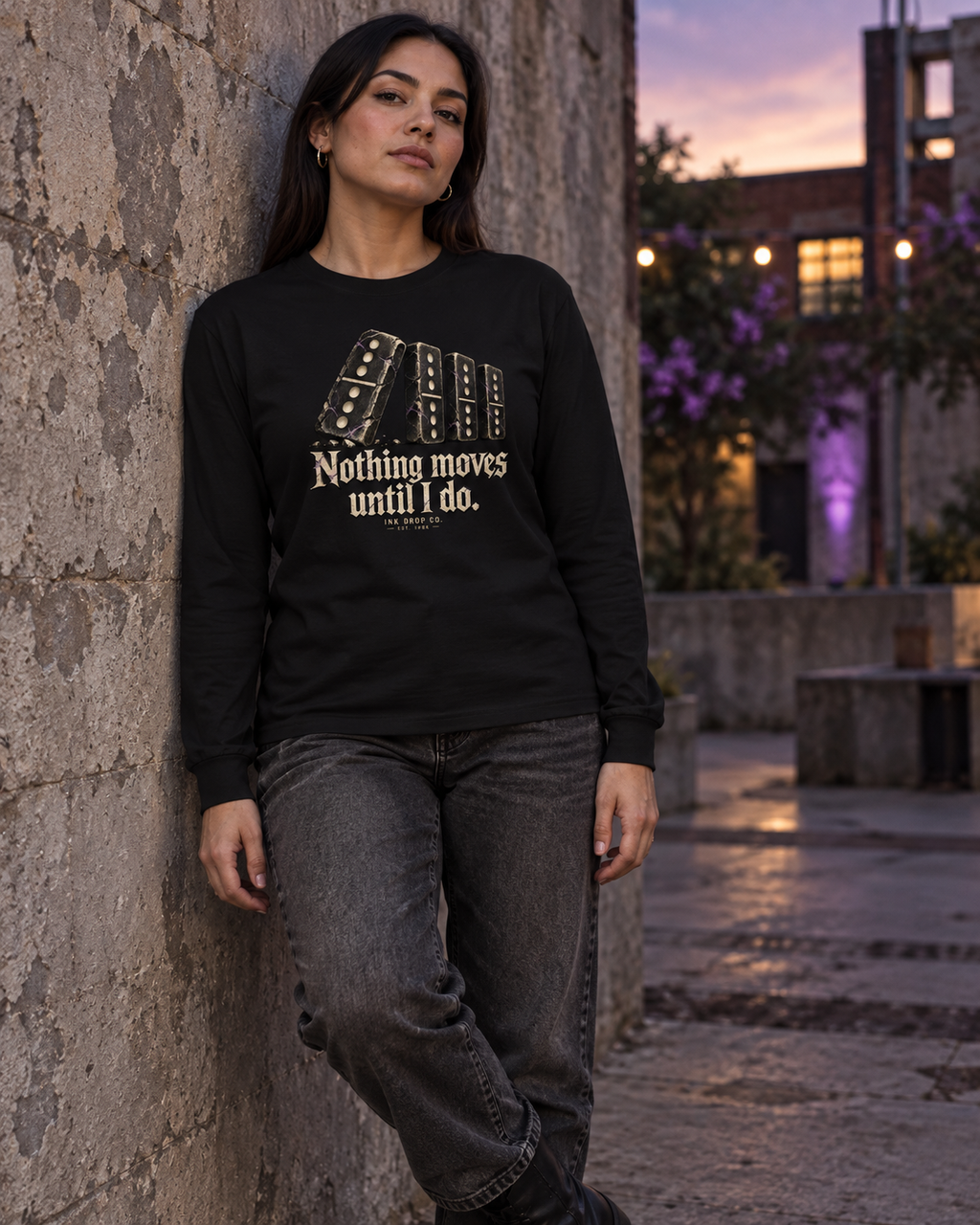 Black unisex long-sleeve tee with gold domino graphic, worn by model
