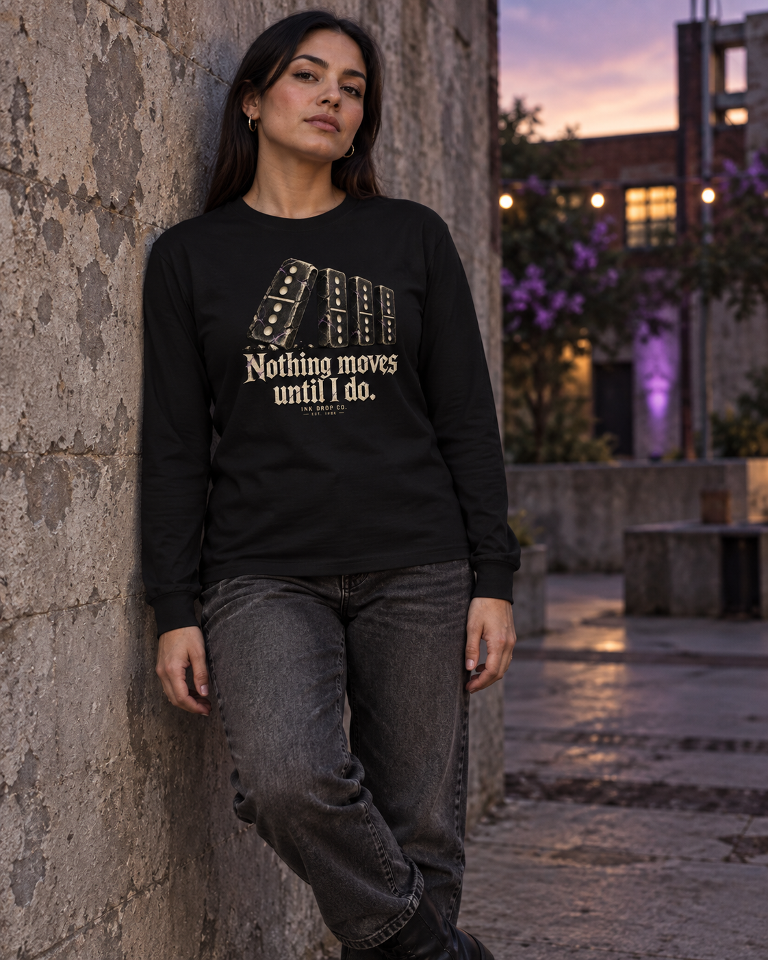 Black unisex long-sleeve tee with gold domino graphic, worn by model