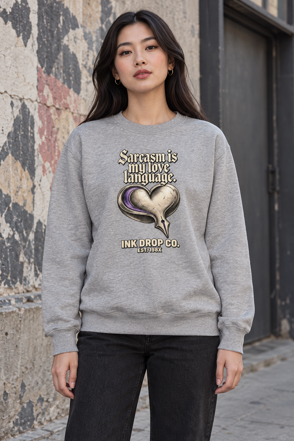 Unisex light gray crewneck sweatshirt with heart graphic, worn by model