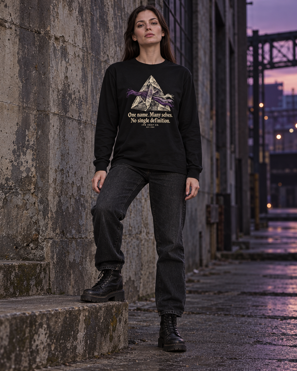 Black long-sleeve graphic tee on model, front mountain illustration and slogan