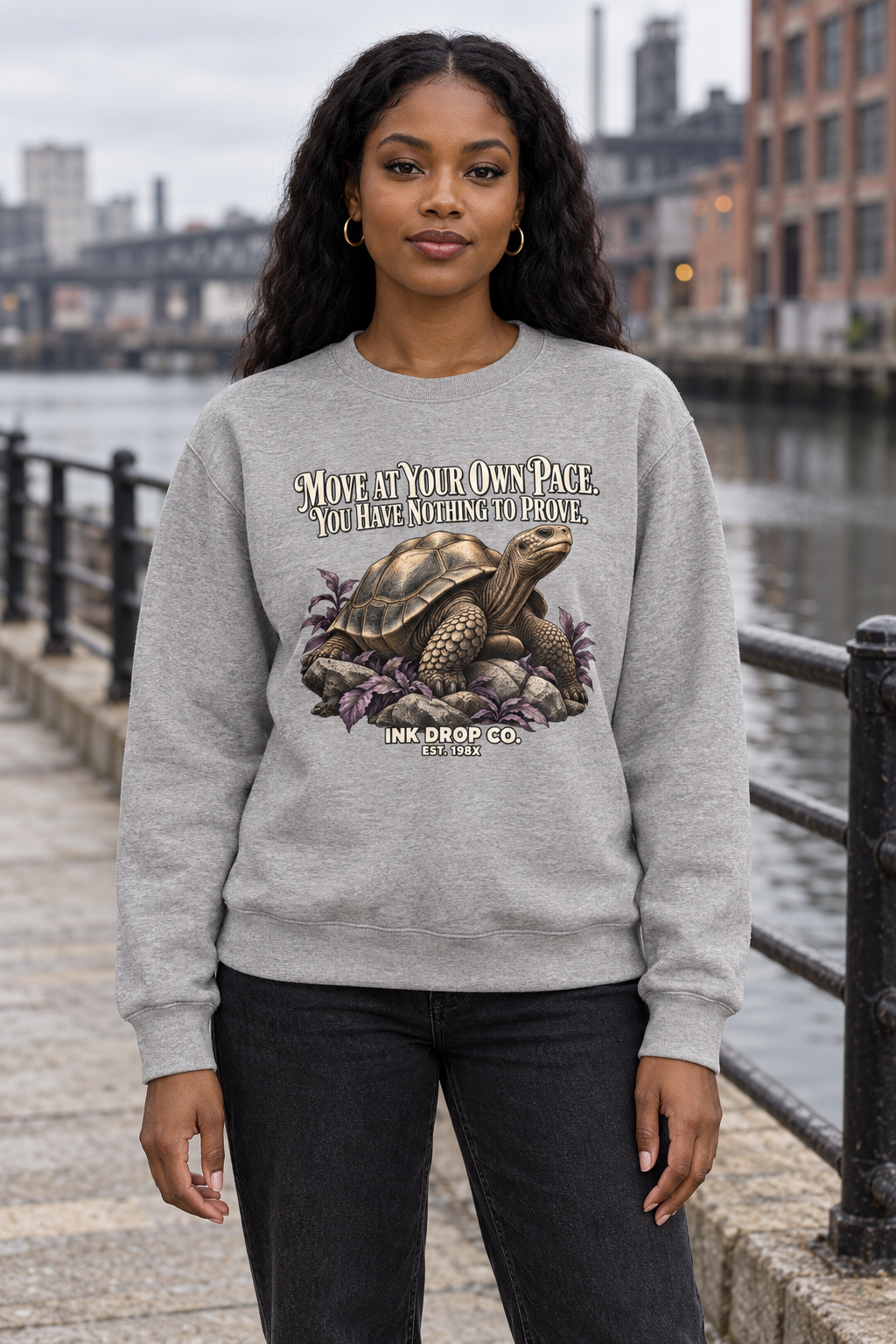 Unisex crewneck sweatshirt in heather gray with front graphic text and dragon emblem