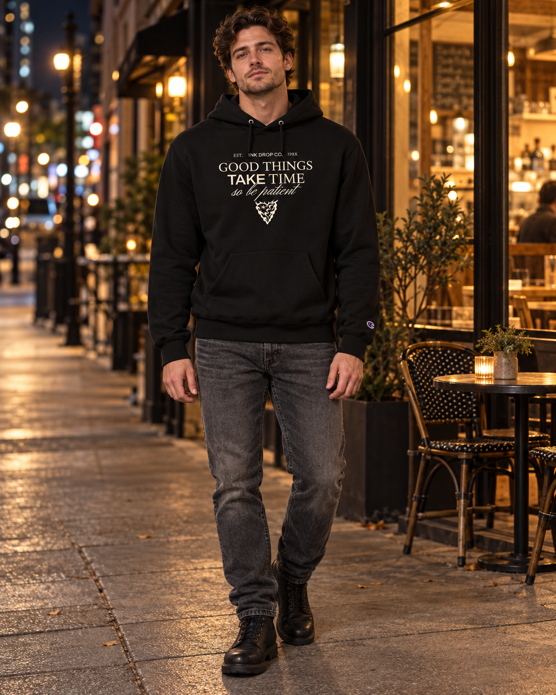 Black unisex pullover hoodie with "Good Things Take Time" chest graphic and pouch pocket