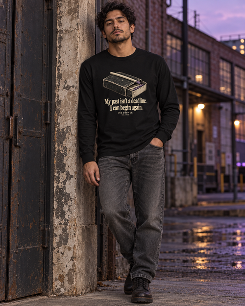 Unisex black long-sleeve crew tee with front quote graphic