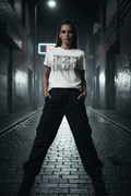 Women's t-shirt with REBEL dripping graphic, crew neck, short sleeves, styled with black pants.