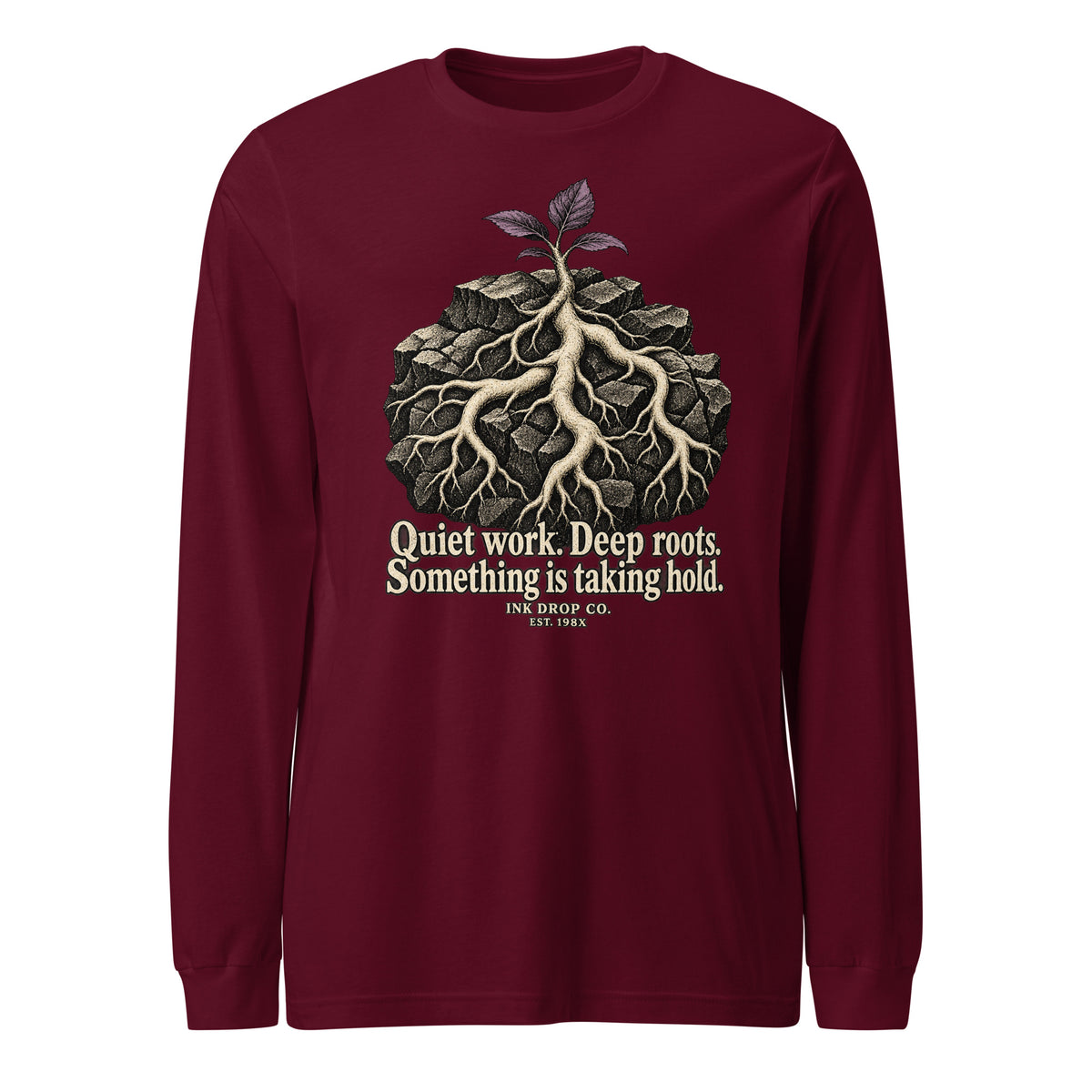 Maroon unisex long-sleeve tee with tree-roots graphic and quote text
