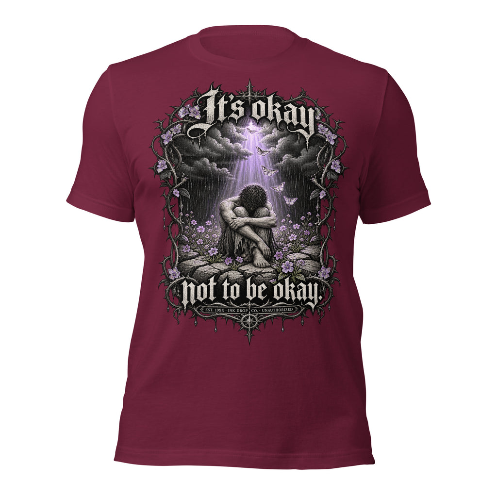 Maroon unisex graphic T-shirt with front print of clouds, flowers, and a kneeling figure