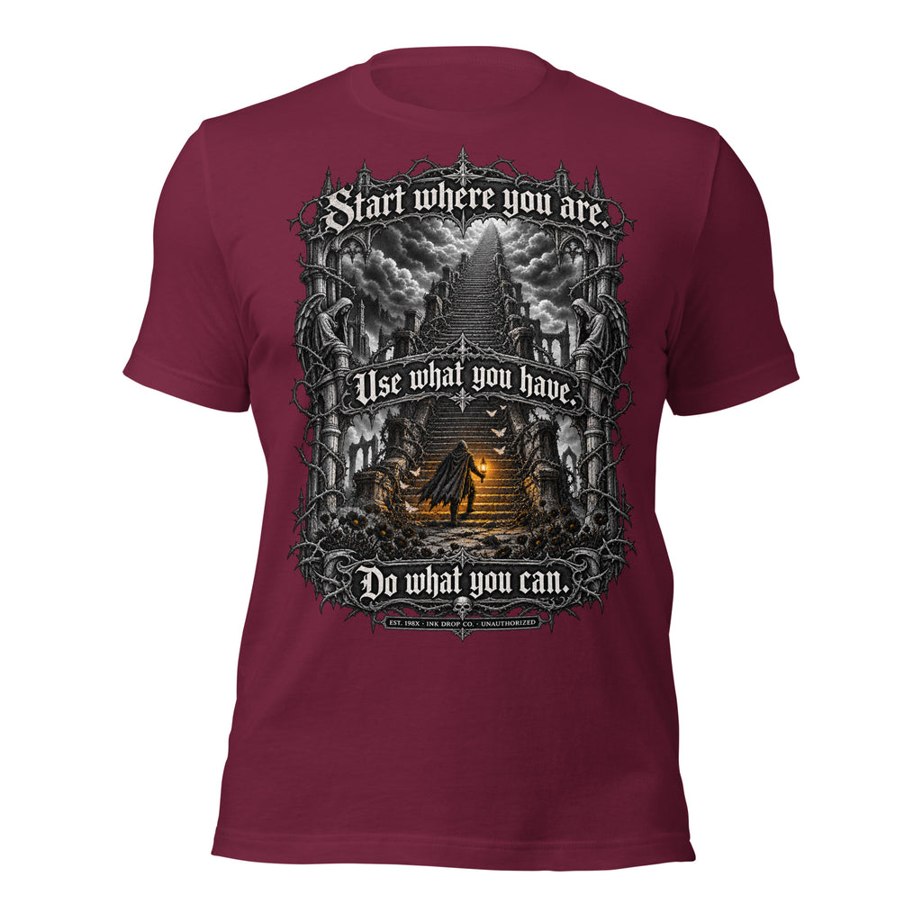 Maroon unisex graphic tee with centered fantasy artwork and text on front